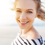 happy woman enjoying freedom and laughs on sea